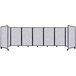 A white rectangular Versare SoundSorb room divider with black wheels.