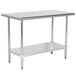 An Advance Tabco stainless steel work table with a galvanized shelf.