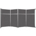 A Versare charcoal gray folding room divider with four panels.
