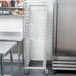 A stainless steel Cres Cor sheet pan rack in a kitchen.