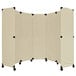 A beige Versare room divider with black wheels.