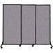 A three panel grey Versare Quick-Wall sliding room divider on wheels.