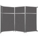 A Versare charcoal gray folding room divider with three panels.
