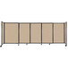 A beige Versare StraightWall sliding room divider with black trim on wheels.