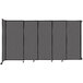 A Versare charcoal gray wall-mounted sliding room divider with wheels.