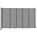 A light gray Versare wall-mounted sliding room divider with black wheels.