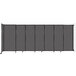 A Versare charcoal gray fabric room divider with wheels.