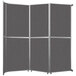 A Versare charcoal gray folding room divider with four panels.