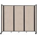 A Versare beige room divider with a black frame and wheels.