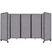 A Versare Cloud Gray foldable room divider with a black frame and four panels of grey fabric.