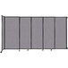 A Versare Cloud Gray wall-mounted sliding room divider with wheels.