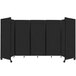 A black rectangular Versare SoundSorb folding room divider on wheels.