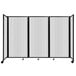 A clear polycarbonate room divider with wheels.