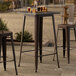 A Lancaster Table & Seating copper bar height table on a patio.