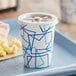 A white and blue Choice paper cold cup with a lid on a tray.