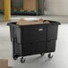 A large black towable cube truck with a 27 cubic foot capacity, designed for transporting materials in industrial or commercial settings.