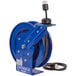 A blue Coxreels heavy-duty power cord reel with a black cord.