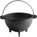 A black cast iron bowl with a handle.