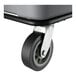A close-up of a caster wheel attached to a gray Lavex 27 cubic foot cube truck.