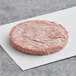 An Impossible Foods vegan plant-based burger patty on a white paper.