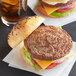 a burger with a bun and a glass of beer