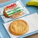 A David's Cookies gluten-free snickerdoodle cookie on a plate next to a banana.