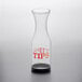 A Tablecraft clear plastic carafe with "tips" in red on the front.