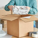 A man holding a Lavex Newsprint Packing Paper roll.