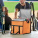 A man opening a Choice orange insulated cooler bag filled with cans of beer.