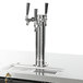 A black Beverage-Air wine dispenser with three stainless steel taps on a counter.