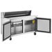 An Avantco stainless steel refrigerator with two doors open on a stainless steel counter.