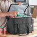 A man putting a can into a Choice medium black insulated cooler bag.