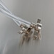 Clear plastic tubing with metal connectors attached to a pipe.