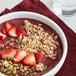 A bowl of Bob's Red Mill Classic Granola with oatmeal and strawberries.