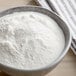 A bowl of Bob's Red Mill Gluten-Free Sweet White Rice Flour on a wooden table.