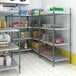 A room with Regency green wire shelving filled with food and other items.