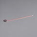 An orange and white LED light with a red and black cable and white tag.