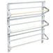 A white metal wall rack with white rods for three paper rolls.