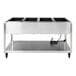 A stainless steel electric four pan hot food table with a lower shelf and power cord.