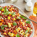 A plate of Goya red kidney beans and corn salad on a table with a spoon.