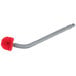 A close-up of a Unger Ergo toilet bowl brush with a red and grey brush and red handle.