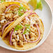 A plate of tacos with Goya Adobo seasoned meat and onions.