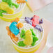 A cup of ice cream with Albanese Gummi Frogs on top.