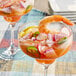 A shrimp cocktail with Goya Aji Rocoto Red Hot Pepper Paste on a table.