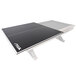 A Stiga ping pong conversion top with a black top and white base on a black table.