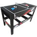 A black and red Triumph 4-in-1 game table with ping pong set up.
