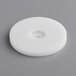 A white circular plastic disc with a hole in it.