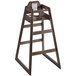 A Lancaster Table & Seating wooden high chair with a vintage finish on a bar table.