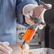 a hand holding a syringe with a liquid in it