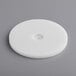 A white circular plastic disc with a hole in it.